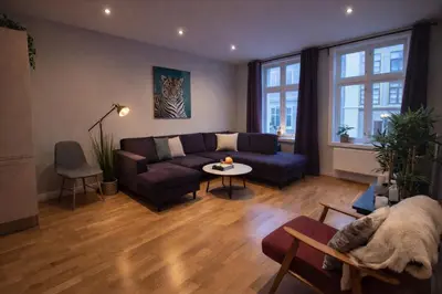 a living room with a couch and a table at Bergen City Center Apartment in Bergen