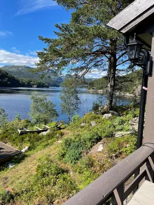 a view of a lake from the porch of a house at Beautiful Cottage by the Sea in Tysse