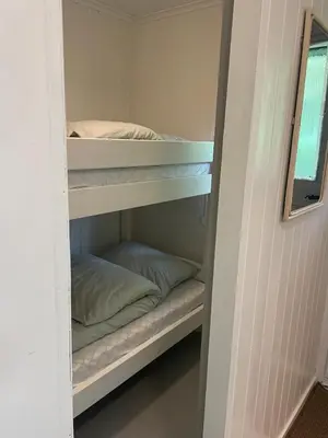 a bunk bed room with bunk beds in it at Beautiful Cottage by the Sea in Tysse