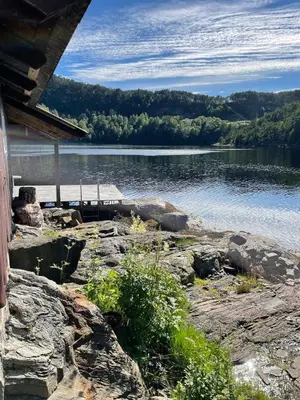 a view of a body of water with a house at Beautiful Cottage by the Sea in Tysse