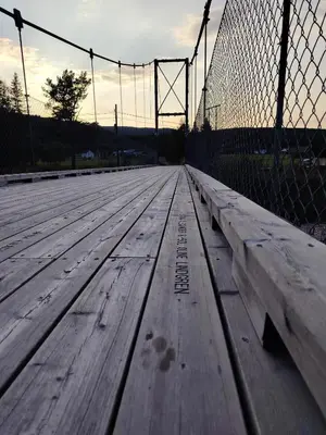 a wooden boardwalk with a fence in the background at Landgård Feriehus in Trysil