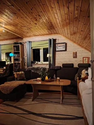 a living room with a couch and a table at Landgård Feriehus in Trysil
