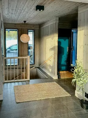 a room with wood paneled walls and a staircase at Modern Cabin With Ski In Out At Kvitfjell in Favang