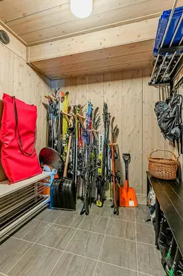 a room with a bunch of skis hanging on the wall at Modern Cabin With Ski In Out At Kvitfjell in Favang