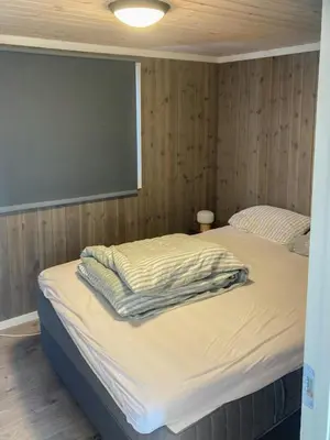 a bedroom with two beds and a chalkboard on the wall at Traditional Cabin In Nøsterbølia in Uvdal
