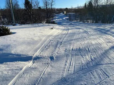 a snow covered road with tracks in the snow at Traditional Cabin In Nøsterbølia in Uvdal