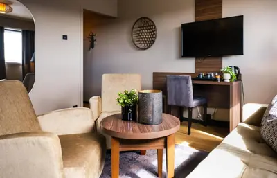 a living room with a couch and a table at Ågotnes Hotell in Ågotnes