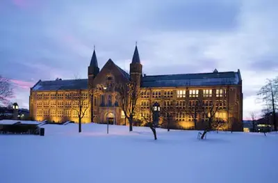 a large building is lit up in the snow at Du vil elske å bo her! Et lite, men koselig sted med perfekt beliggenhet! in Trondheim