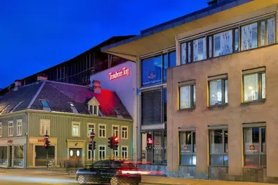 a car driving down a street next to a building at Du vil elske å bo her! Et lite, men koselig sted med perfekt beliggenhet! in Trondheim