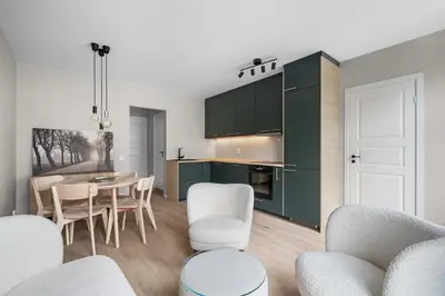 a kitchen and dining room with a table and chairs at Bergen Beds Apartments I Urban Escape in Bergen