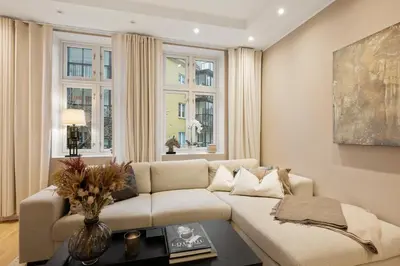 a living room with a couch and a table at Luxury Summer Apartment with Balcony Near Bryggen in Bergen