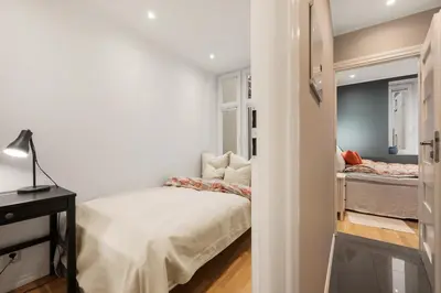 a bedroom with a bed and a mirror at Luxury Summer Apartment with Balcony Near Bryggen in Bergen