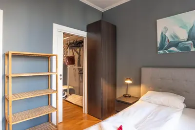 a bedroom with a bed and a walk in closet at Roomsly Apartments - Prime Location and Modern Comfort in Bergen