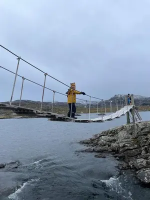 a person standing on a bridge over a body of water at Cottage in scenic surroundings in Hol