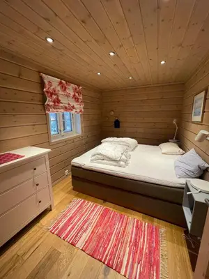 a bedroom with a bed in a wooden room at Cottage in scenic surroundings in Hol