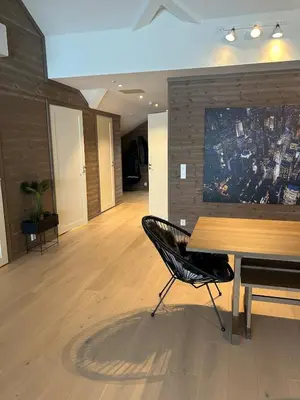 a dining room with a wooden table and a chair at Gorgeous apartment in Geilo in Hol