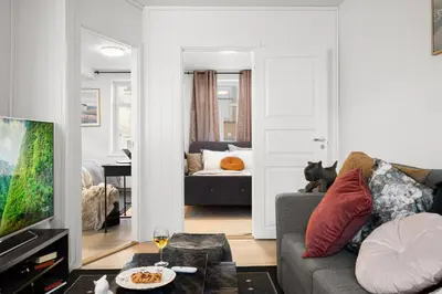 a living room with a couch and a tv at Nord Apartments in Trondheim