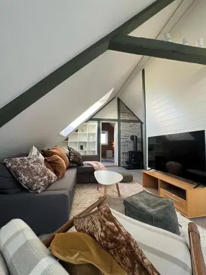 a living room with a couch and a tv at Nord Apartments in Trondheim