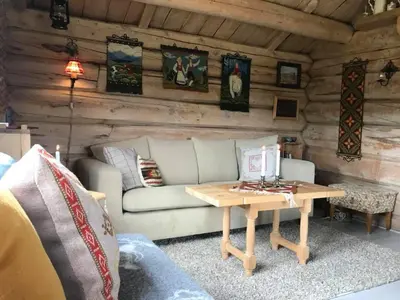 a living room with a couch and a table at Charming lodge from 1888 in Sel
