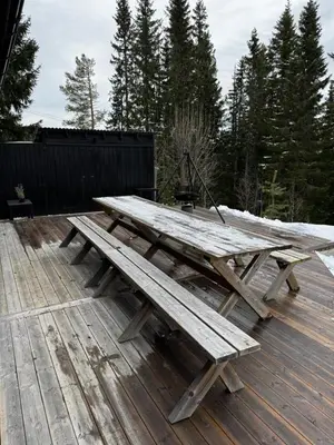 a wooden picnic table sitting on a deck at Ål-hytte i Snertingdal på solrik tomt med suveren beliggenhet in Gjøvik