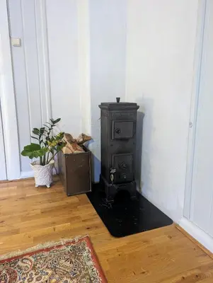 a stove in the corner of a room at Large Family Friendly Apartment in Lillehammer