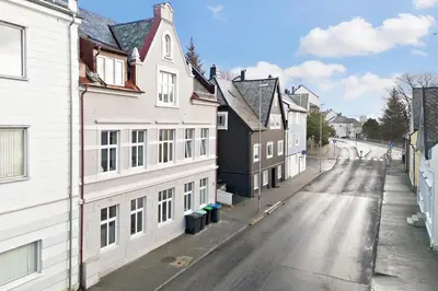 an empty street in a town with white buildings at Modern 4 room apartment Ålesund center in Ålesund