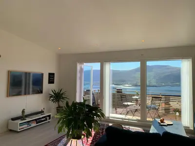 a living room with a view of the ocean at Elegant Townhouse, Breathtaking Views and Free Parking in Ålesund