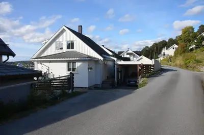 a white house on the side of a road at House with all amenities for rent in Steinkjer