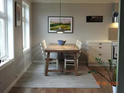 a dining room with a wooden table and chairs at House with all amenities for rent in Steinkjer