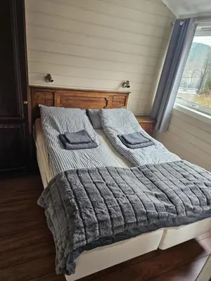 a bed with two pillows on it in a bedroom at Storehorn apartments, Hemsedal - 2 bedrooms, 5 beds in Torset