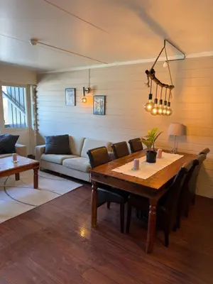 a living room with a wooden table and a couch at Storehorn apartments, Hemsedal - 2 bedrooms, 5 beds in Torset