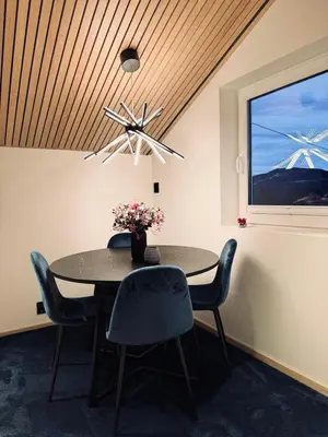 a dining room with a table and chairs and a window at Cozy Apartment in Melhus in Melhus