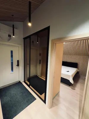 a room with a bedroom with a bed and a mirror at Cozy Apartment in Melhus in Melhus