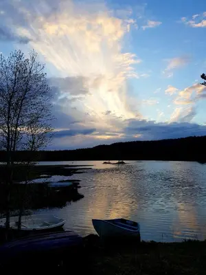 two boats sitting on the shore of a lake at Cabin Room on DaVita Ranch in Tranhaug