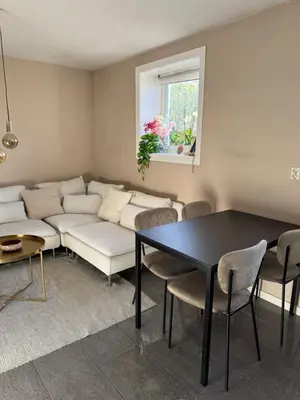 a living room with a couch and a table at Cozy apartment near city center and the mountains in Bergen