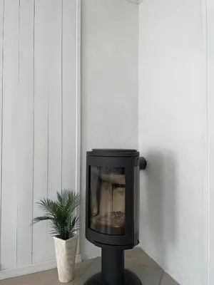 a tv sitting on a stand next to a plant at Modern and Cosy apartment in Bergen City Centre in Bergen