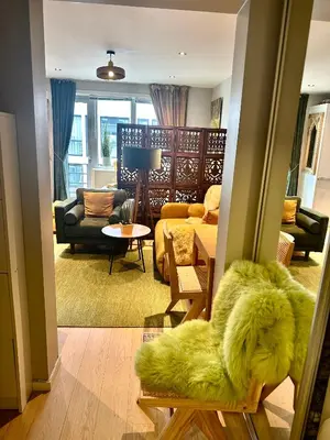 a living room with a couch and a table at Stylish free parking Studio central with balcony in Ålesund