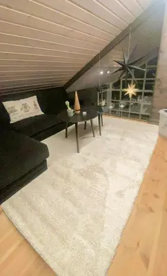 a living room with a couch and a table at Modern Apartment At Strandafjellet Ski Resort in Stranda