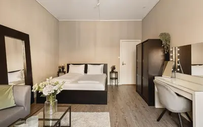 a bedroom with a bed and a living room at Fløyen Suites - Private Rooms with the best location in Bergen in Bergen