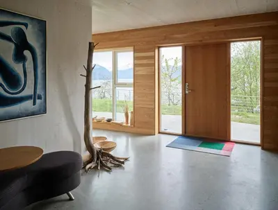 a living room with a tree in the middle of the room at Villa Fjord View in Stranda