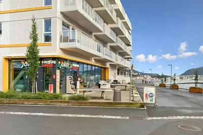 a building with a store on the side of a street at Modern apartment by the sea in Bergen