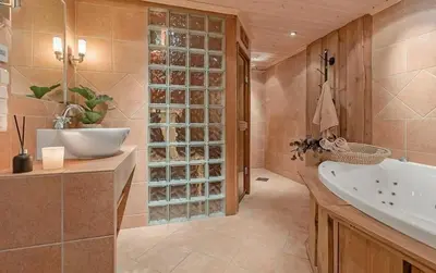 a bathroom with a tub and a sink and a bath tub at Modern Cabin With Ski In-Out In Hafjell in Øyer