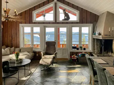 a living room with a cat sitting in a window at Modern Cabin With Ski In-Out In Hafjell in Øyer