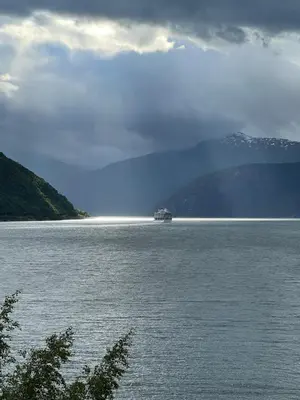 a boat in the middle of a large body of water at Eidfjord Fjell in Eidfjord