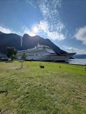 a cruise ship is docked next to a mountain at Eidfjord Fjell in Eidfjord