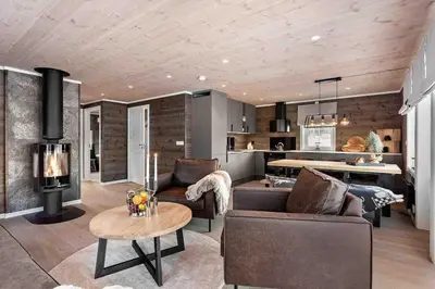 a living room with a couch and a table at Ny, stor hytte nær Røros sentrum! in Røros