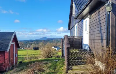 a house with a staircase next to a building at 1 Bedroom Amazing Apartment In Stord in Stord