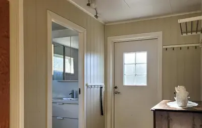 a bathroom with a sink and a mirror and a door at 1 Bedroom Amazing Apartment In Stord in Stord