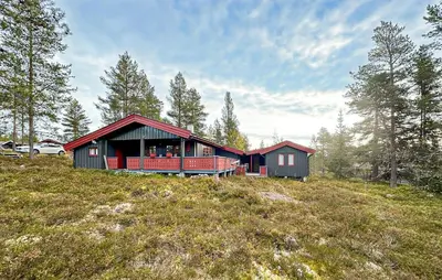a house on top of a hill in a field at Beautiful Home In Jordet With Sauna in Lybekk