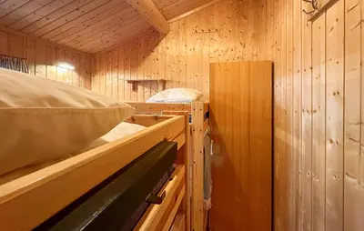 a cabin with wooden walls and a sink in it at Beautiful Home In Jordet With Sauna in Lybekk